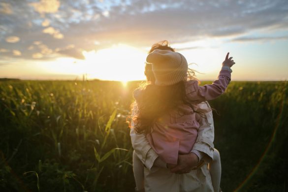 A mother holding her child, representing natural gut health support for autistic children through probiotics, nutrition and holistic healing.